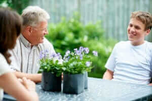 parents and son talking in the garden during the family program