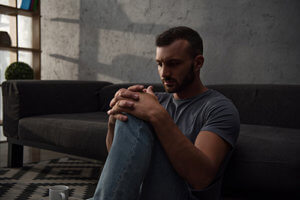 young man sitting alone struggling with a Stimulant Drug Addiction