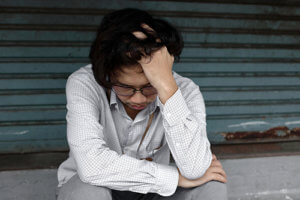 young man sitting outside struggling with a Synthetic Drug Addiction