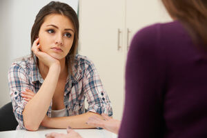 young girl talking with her therapist during Teen Mental Health Treatment