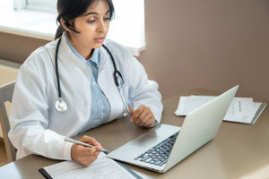 doctor walks patient through a telehealth appointment 