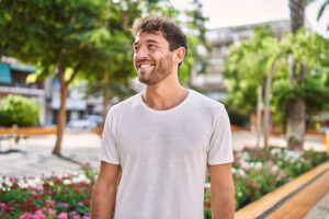 Man smiles as he walks outside after sober living program