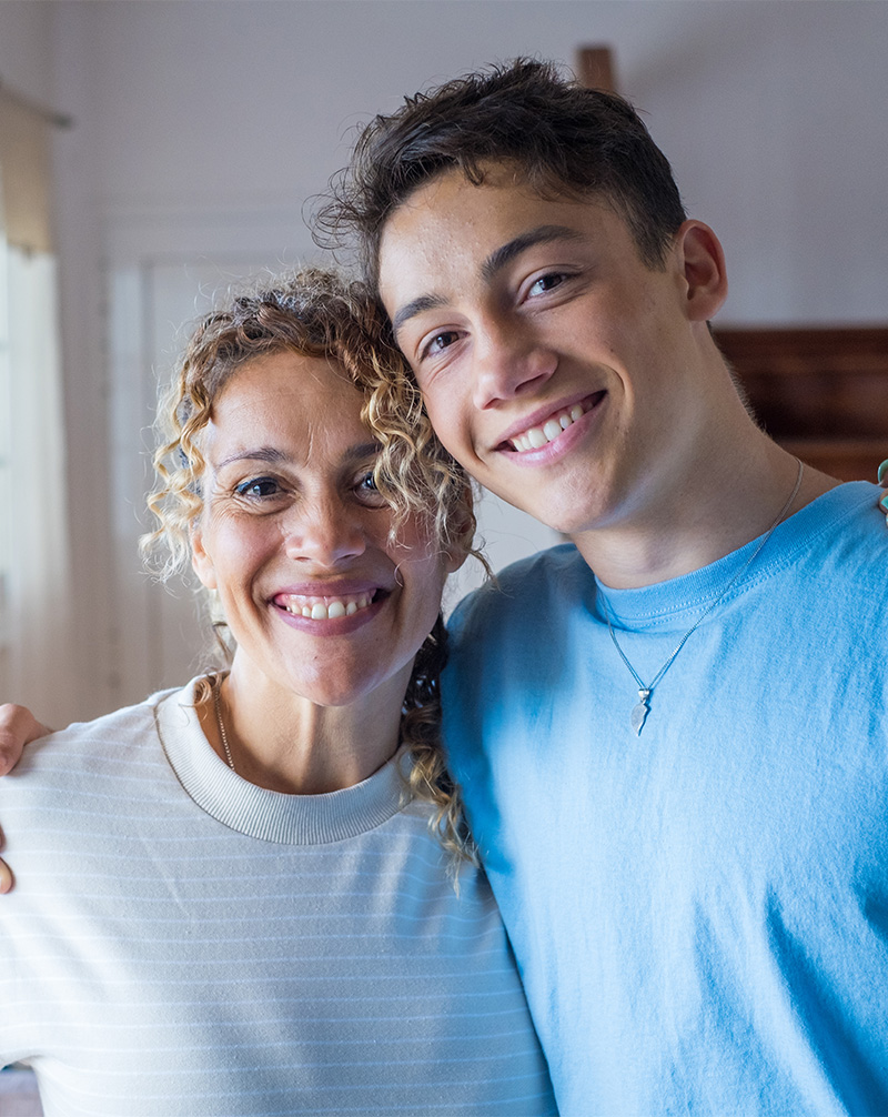 Teen puts arm around mom