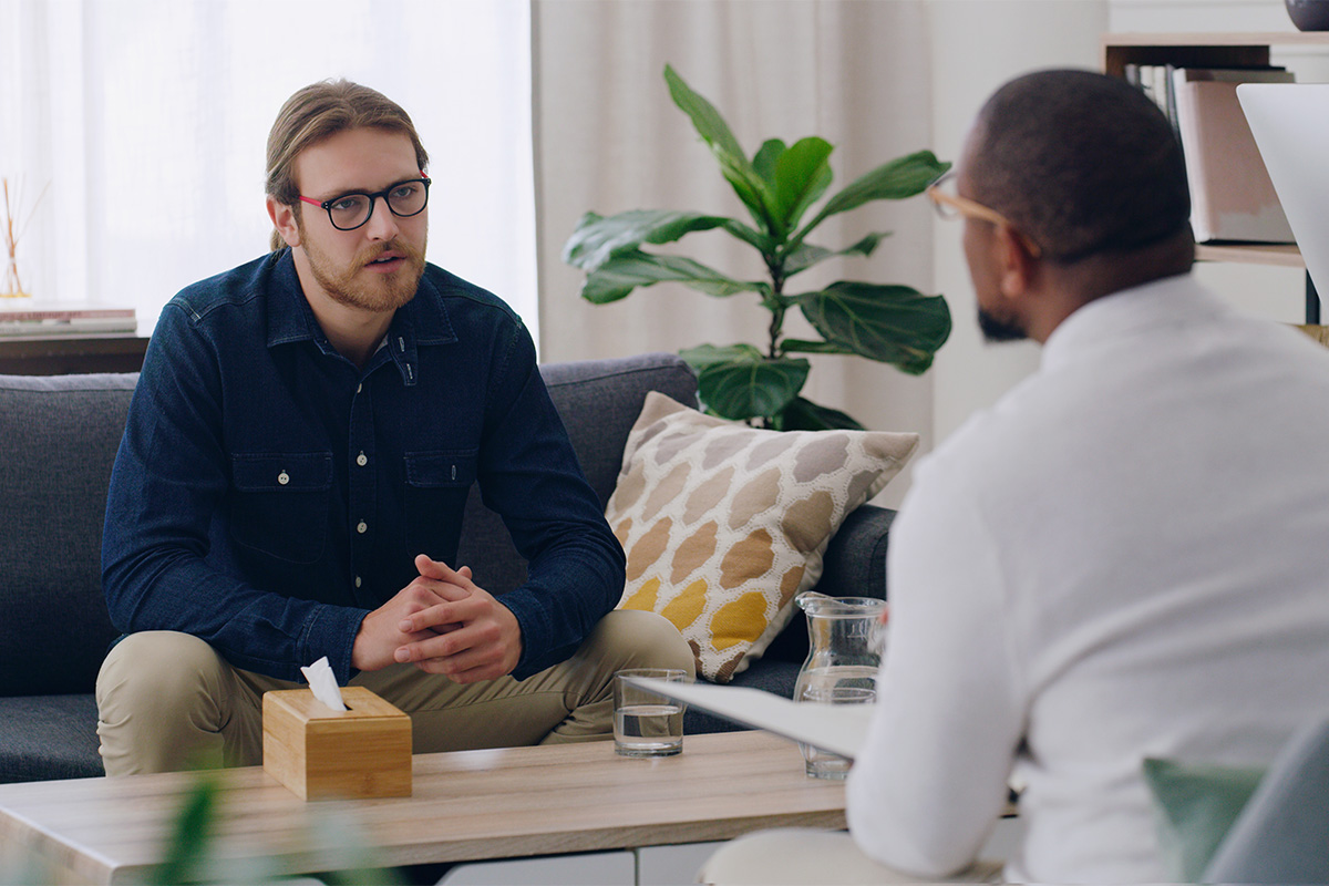 Man talks to therapist during drug addiction treatment