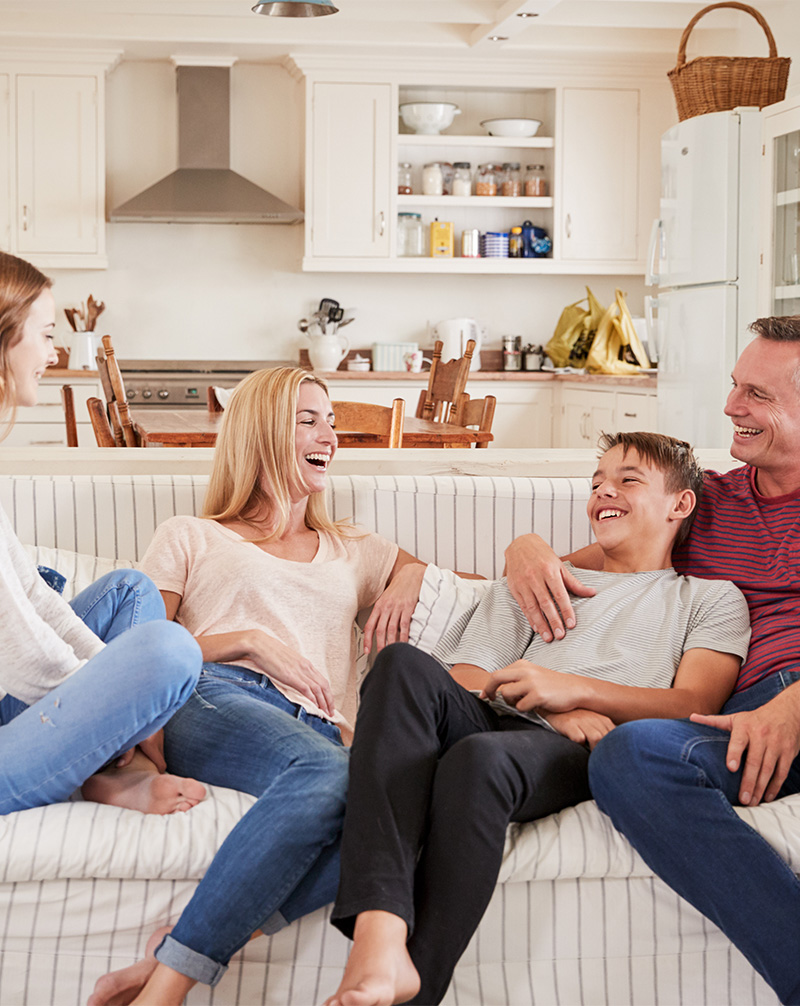Family bond and laugh while sitting on couch