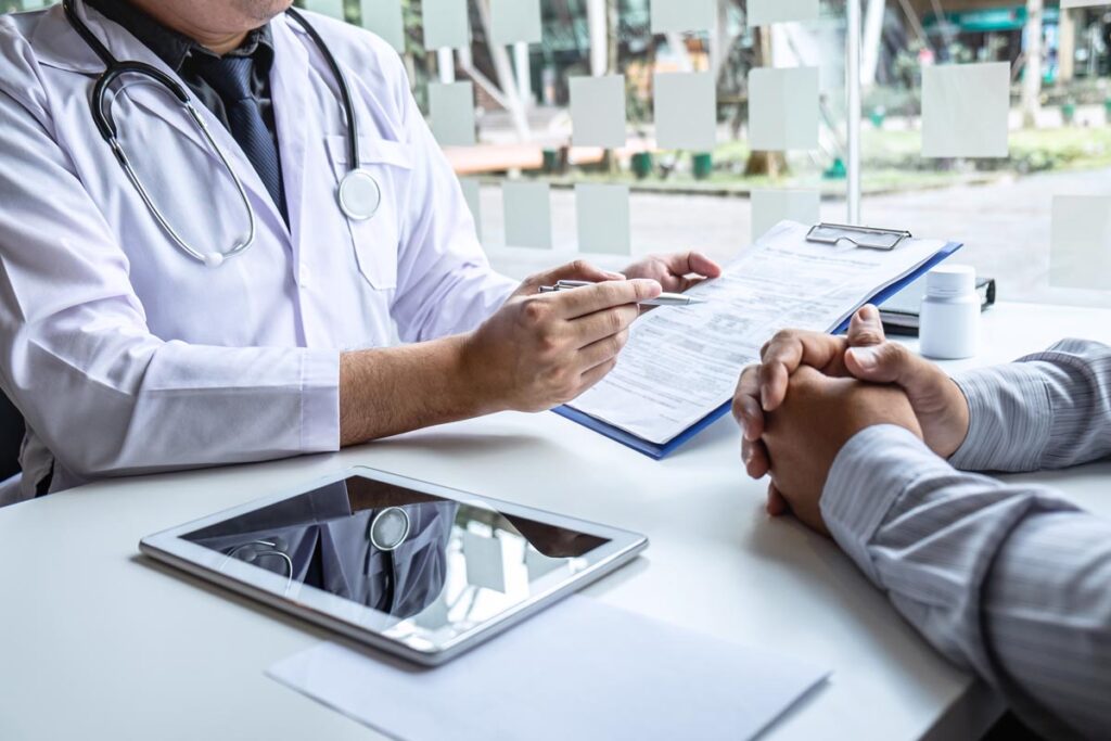 Doctor explaining paperwork to a patient
