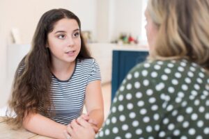 Teen talking to an adult about a teen php program in Boise, ID