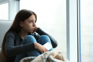 Teen girl staring out the window