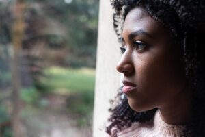Young adult lookin out a window