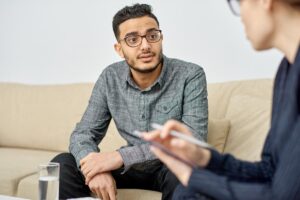 Man with glasses sitting in a cognitive behavioral therapy program in Boise, ID