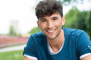 A young man smiles after choosing Boise Rehab Centers