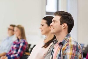 A group of teens smile in group therapy in teen rehabilitation