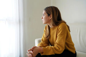Woman sits on chair and wonders if substance abuse affects mental health