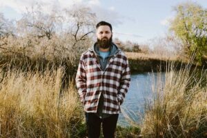 Man stands in front of field while wondering does idaho have a drug problem