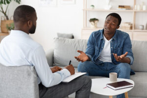 Man sits on couch and asks therapist what is substance abuse evaluation