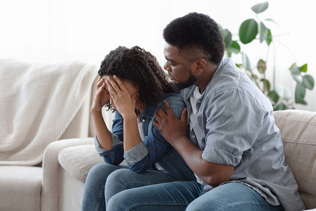Two people wondering, "What causes PTSD in adults?"