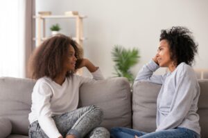 Mother and teenage daughter having a supportive conversation at home, representing early intervention for teen substance use in Boise, Idaho