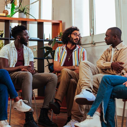 Group talk and smile in addiction therapy program